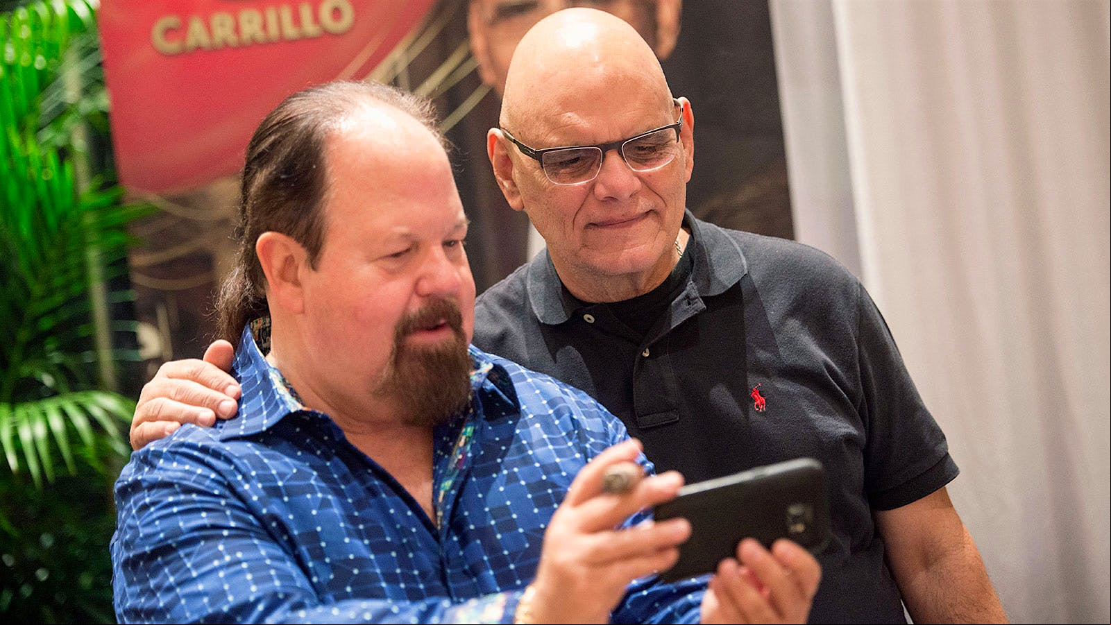 Ernesto Perez-Carrillo of EPC Cigar Co. takes a photo with Larry Burdette at the Big Smoke Evening party.