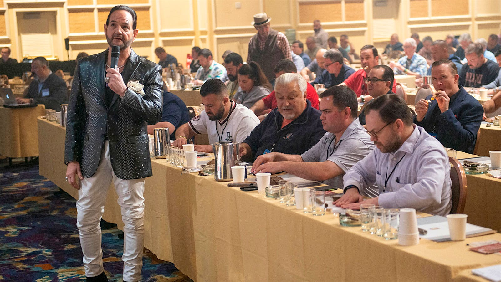 Michael Giannini of Ventura Cigar Co., instructing the crowd on how to roll their own cigars.